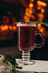 Blackberry mulled wine with rosemary in a glass cup