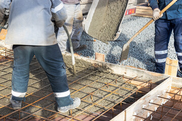 Pouring cement or concrete with a concrete mixer truck, construction site with a reinforced...