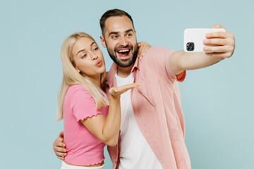 Young fun couple two friends family man woman in casual clothes doing selfie shot on mobile cell...