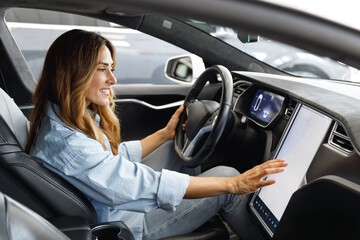 Side profile view caucasian happy smiling confident satisfied woman drive hold put hand on steering...