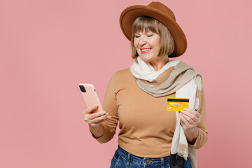 Traveler tourist elderly senior woman 55 years old wears brown shirt hat scarf using mobile cell...