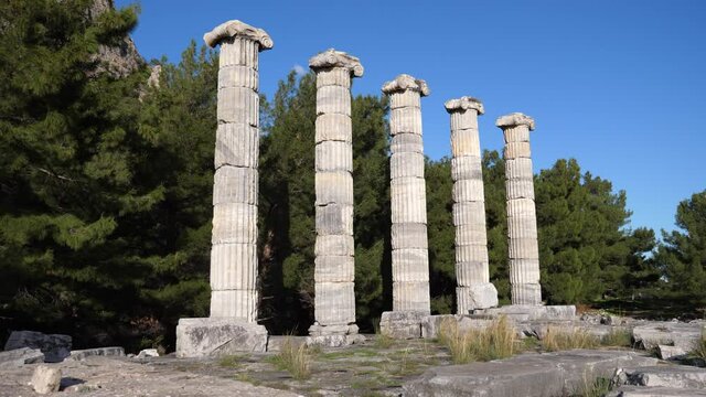 Ruins of Temple of Athena in ancient Greek city of Priene overlooking five reconstructed columns on sunny winter day, Turkey