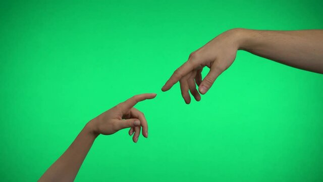 Two hands touch with fingers on a green background.