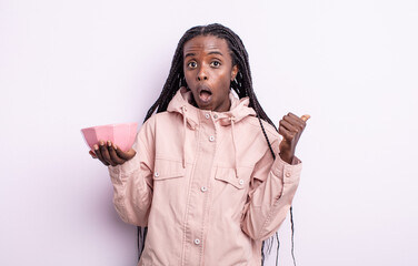 pretty black woman looking astonished in disbelief. empty bowl concept