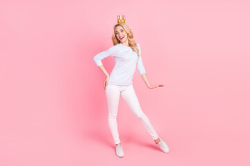 Full length photo of cheerful young happy woman queen wear golden tiara isolated on pink color background