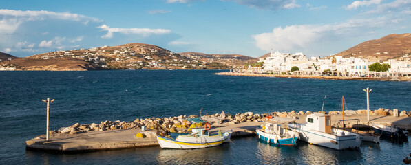 Boats standing in pier and town on back view. Greece. Paros
