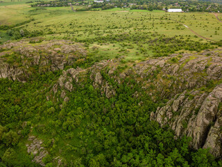 Obraz premium Top view from drone on green hills area
