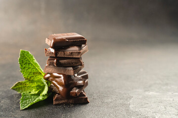 Chocolatier cover melted chocolate tower pieces chocolates with mint. recipe Cooking handmade chocolate bar, dessert, candies. Confectionery covered with chocolate topping with mints leaf