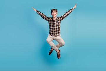 Fototapeta na wymiar Full size photo of young cheerful guy have fun jump dream cool fly isolated on violet color background