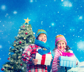 caucasian kids holding gift for christmas