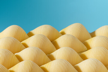 Pasta conchiglioni or conchiglie pattern with blue background. Abstract creative food concept