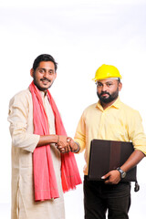 Young indian engineer shake hand with farmer on white background.
