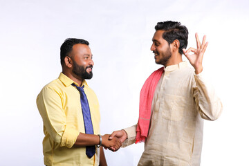 Young indian officer shake hand with farmer on white background.