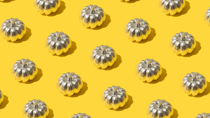 Trendy pattern with silver pumpkin on bright yellow background. Futuristic fall holiday concept.