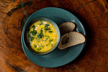 Warm seasonal chicken and cheese soup with a couple of bread slices, top view, menu photo
