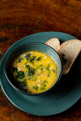 Warm seasonal chicken and cheese soup with a couple of bread slices, top view, menu photo
