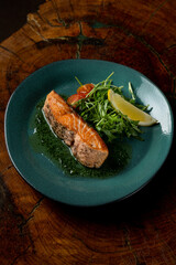 Roasted salmon steak in a dark restaurant