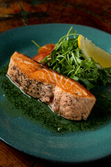 Roasted salmon steak in a dark restaurant