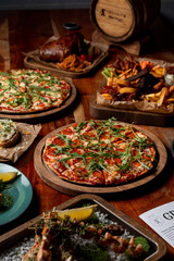 Whole menu of an expensive restaurant, a lot of different meals on a wooden table, dark warm light