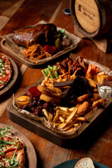Assortment of hot beer snacks, dark warm atmosphere of beer restaurant