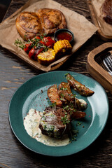 Steakhouse menu, assortment of meat meals on dark wooden table
