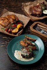 Steakhouse menu, assortment of meat meals on dark wooden table