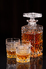Crystal decanter and two glasses of alcoholic drink