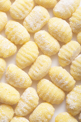 Raw italian gnocchi on a white background. Top view pattern