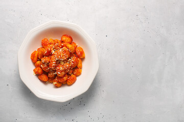 Traditional gnocchi with tomato sauce and cheese in a white plate with copy space