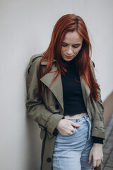 Young woman outdoor portrait. Freckled face girl with red hair, natural beauty face