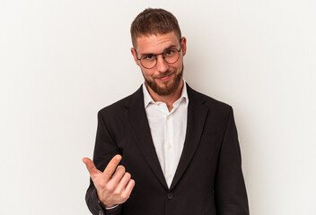 Young business caucasian man isolated on white background pointing with finger at you as if inviting come closer.