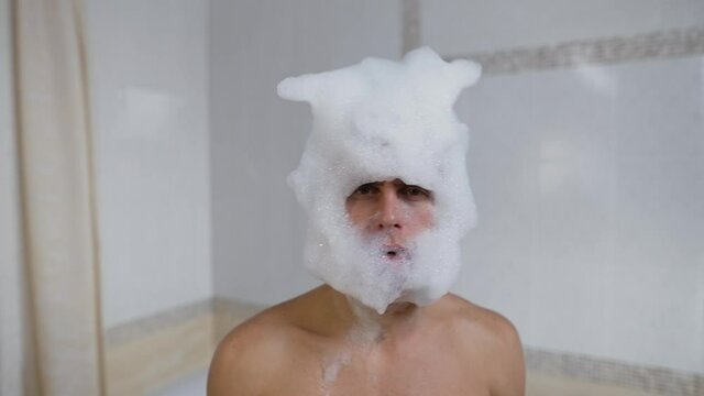 Head of man in a soapy foam