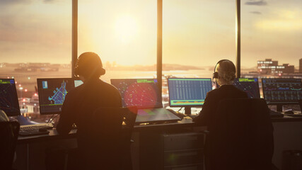 Diverse Air Traffic Control Team Working in Modern Airport Tower at Sunset. Office Room Full of...