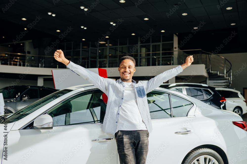 Canvas Prints African man feeling happiness while buying car at salon