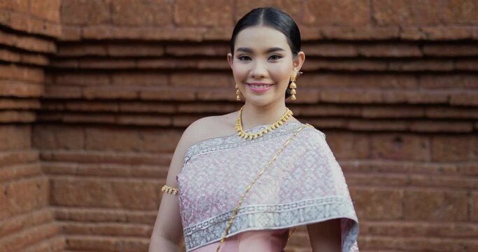 Thai woman in traditional costume looking at camera