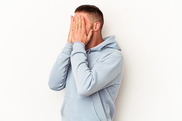 Young caucasian man with diastema isolated on white background afraid covering eyes with hands.