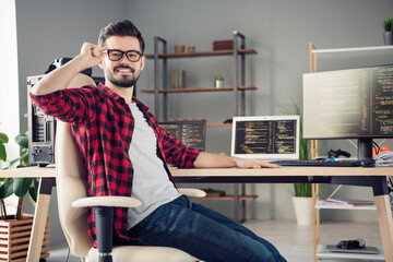 Profile side view portrait of attractive skilled cheerful guy writing code touching specs at work place station indoors