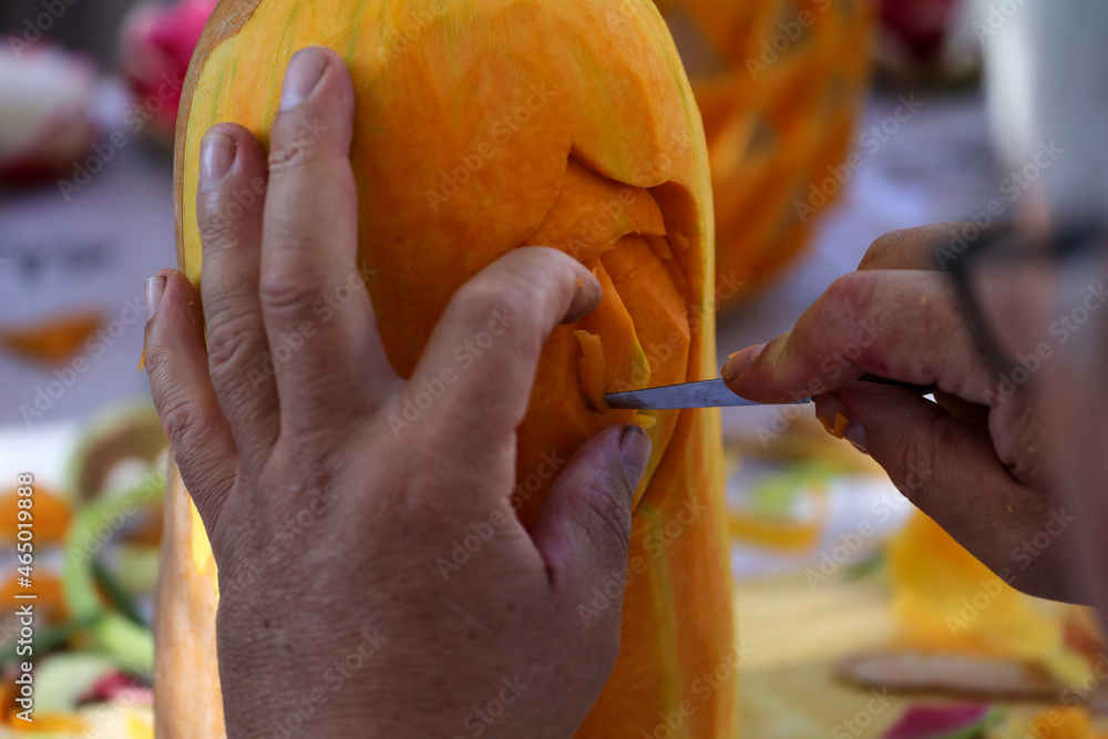 Wall mural pumpkin carver working on project