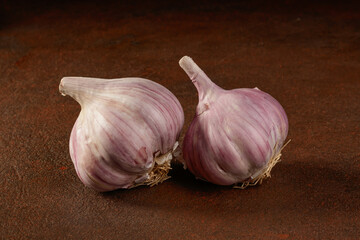 Close-Up Of Garlics On Brown Background