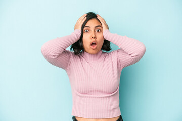 Young latin woman isolated on blue background being shocked, she has remembered important meeting.