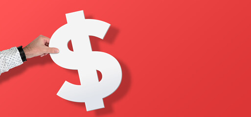 hand holding large Dollar symbol against red background with copy space, financial concept