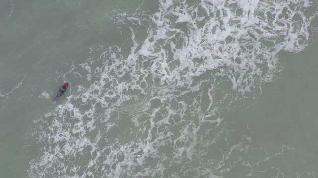 surfista sobre una tabla con el mar agitado