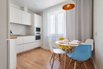 white kitchen with Scandinavian-style dining area