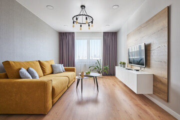 TV area with wooden decor and a yellow Scandinavian-style sofa