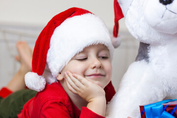 Portrait of a cute boy in a Santa Claus hat. Funny smiling child.
