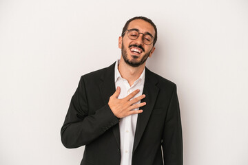 Young caucasian business man isolated on white background laughs out loudly keeping hand on chest.