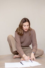 business woman sitting at the table with pencil in hand