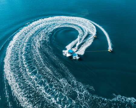drone photo of extreme powerboat with two donuts water-sports