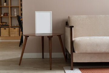 White frame mockup on vintage wooden table. Scandinavian interior. Beige living room design
