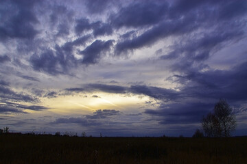 Heavy autumn clouds in the sky at sunset